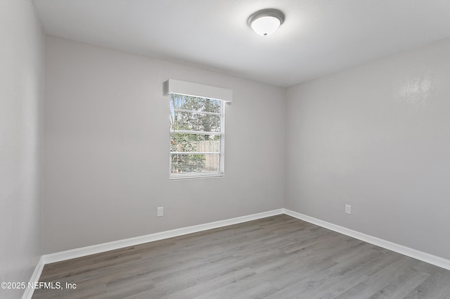 spare room with hardwood / wood-style flooring