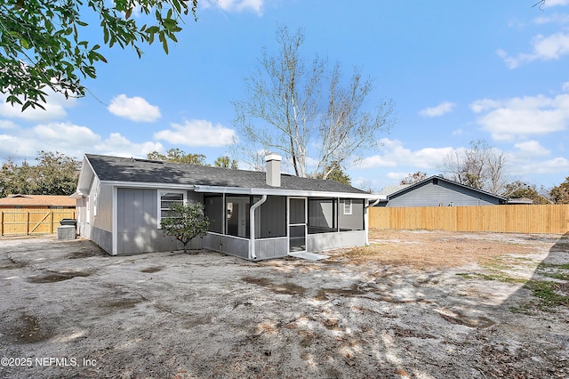 rear view of property with a sunroom