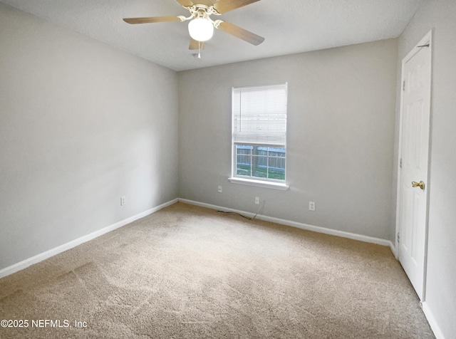 empty room featuring a textured ceiling, carpet floors, and ceiling fan