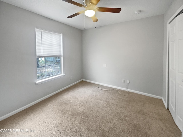 unfurnished bedroom featuring carpet, ceiling fan, and a closet