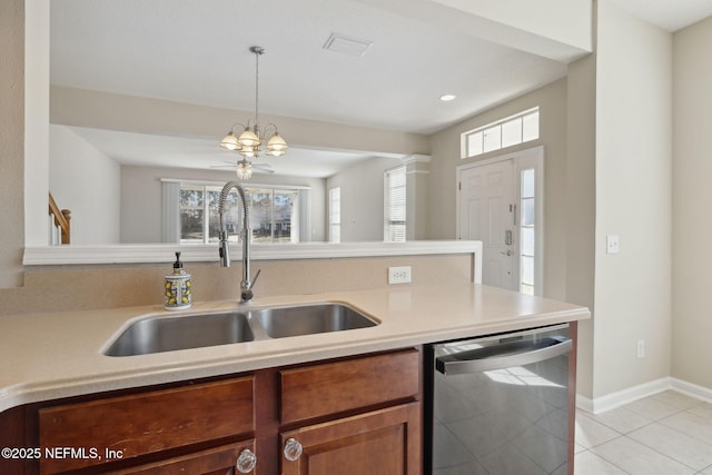 kitchen featuring dishwasher, sink, hanging light fixtures, and a wealth of natural light