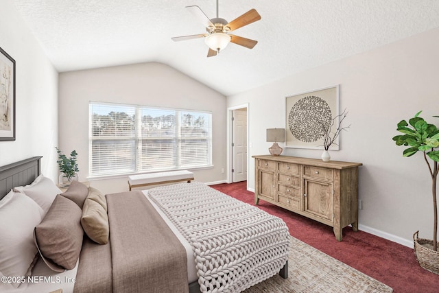 bedroom featuring lofted ceiling, ceiling fan, dark carpet, and a textured ceiling