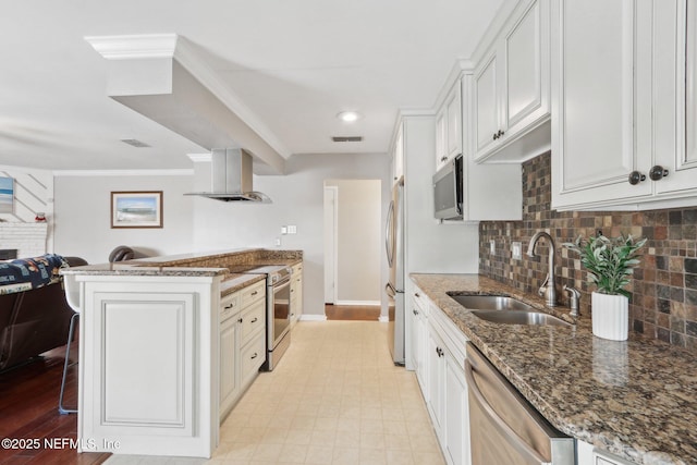 kitchen with sink, white cabinetry, appliances with stainless steel finishes, island exhaust hood, and dark stone counters