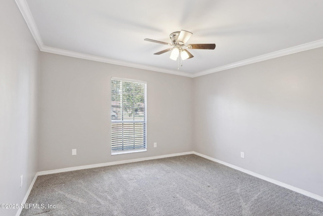 carpeted spare room featuring ornamental molding and ceiling fan