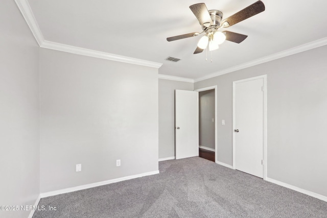 empty room featuring crown molding, carpet, and ceiling fan