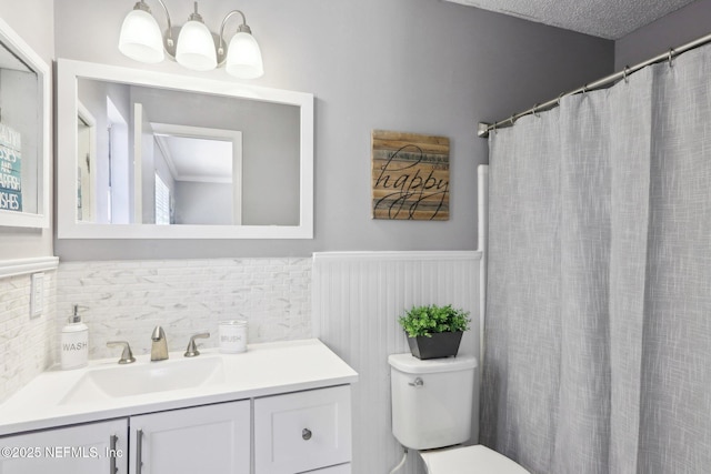 bathroom featuring vanity, a notable chandelier, and toilet