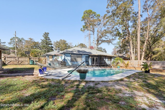 rear view of house featuring a fenced in pool, a gazebo, a yard, and a patio area