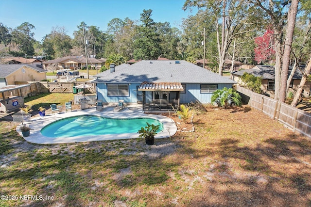 view of pool featuring a yard and a patio