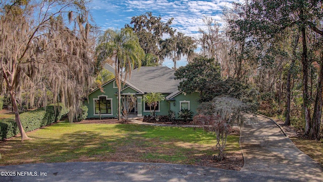 obstructed view of property with a front yard