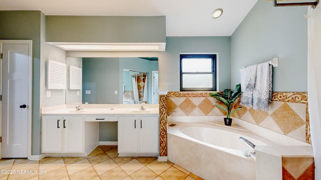 full bath featuring double vanity, a garden tub, a sink, and tile patterned floors