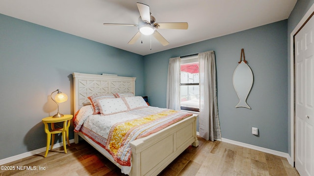 bedroom with a ceiling fan, light wood-style flooring, and baseboards