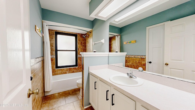 full bath with toilet, tile walls, vanity, tile patterned floors, and shower / bathtub combination with curtain