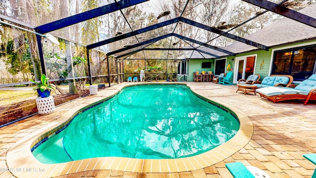 pool featuring a lanai, a patio area, and an outdoor living space