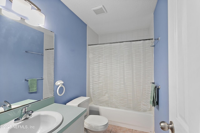 full bathroom featuring tile patterned flooring, vanity, toilet, a textured ceiling, and shower / bath combo with shower curtain