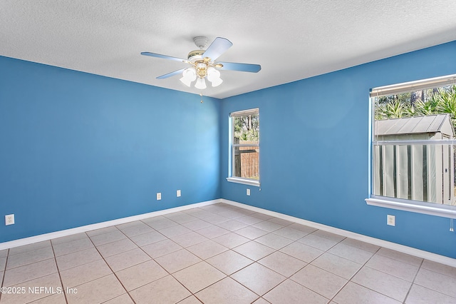 tiled spare room with a textured ceiling and ceiling fan