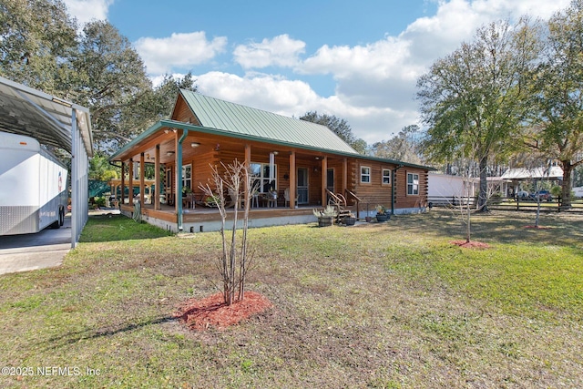 rear view of property with a porch and a yard