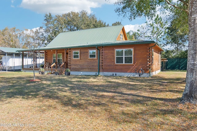 rear view of property with a yard