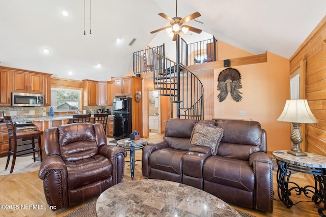 living room featuring high vaulted ceiling, ceiling fan, and light hardwood / wood-style flooring