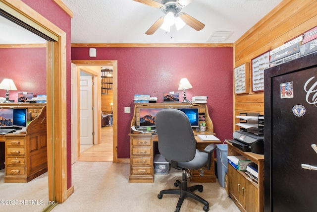 office with ceiling fan, a textured ceiling, and wood walls