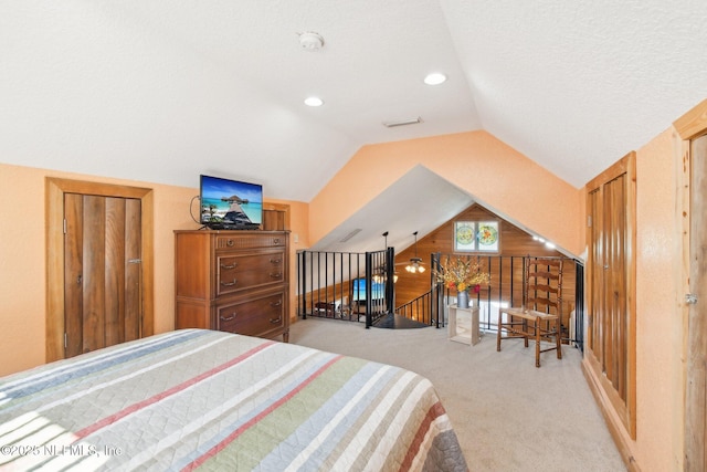 carpeted bedroom featuring lofted ceiling and wood walls