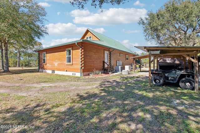 view of side of home featuring a carport and cooling unit