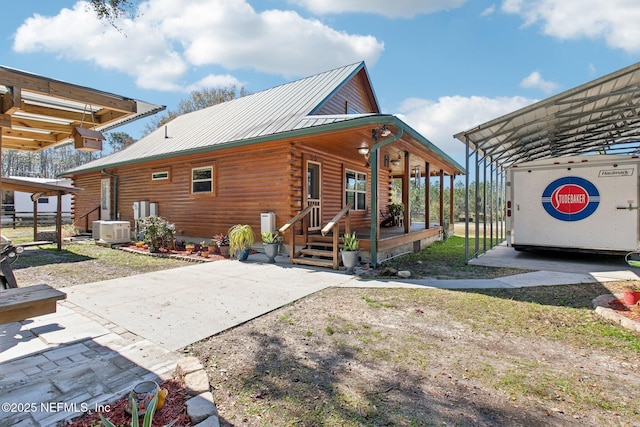 back of house featuring a carport and central air condition unit