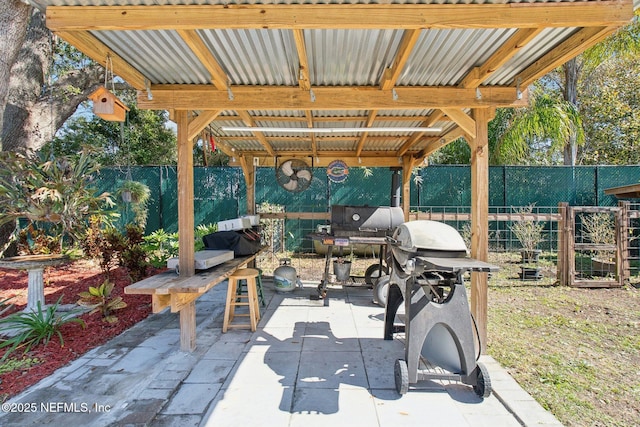 view of patio with a grill and exterior fireplace