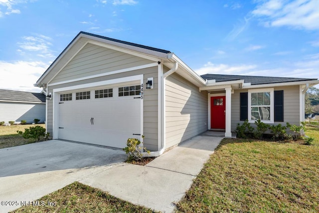 ranch-style home with a garage and a front lawn