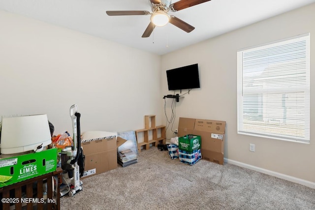 interior space featuring ceiling fan and carpet flooring