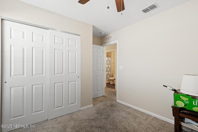 unfurnished bedroom with ceiling fan, carpet flooring, and a closet