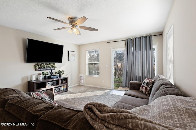 carpeted living room featuring ceiling fan