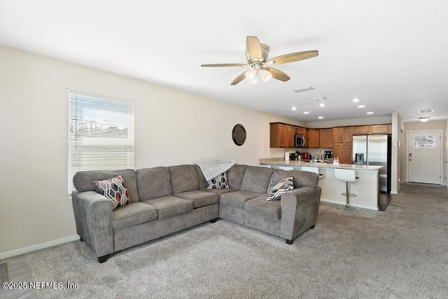 living room with light colored carpet and ceiling fan