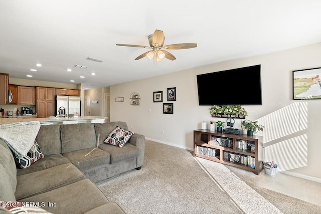 carpeted living room featuring ceiling fan