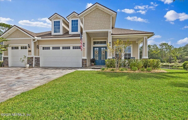 view of front facade featuring a front yard and french doors