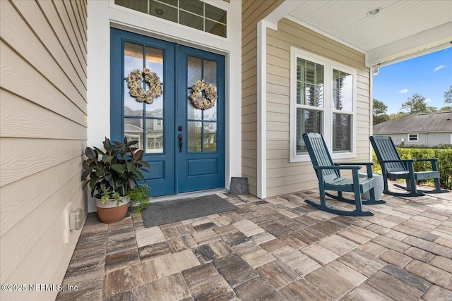 doorway to property with french doors and a porch