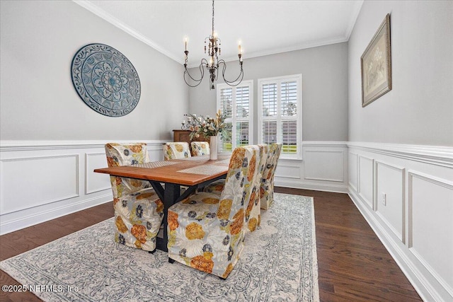 dining area featuring ornamental molding, a notable chandelier, and dark hardwood / wood-style flooring