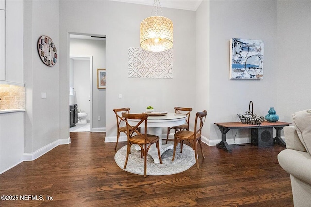 dining area with dark hardwood / wood-style flooring