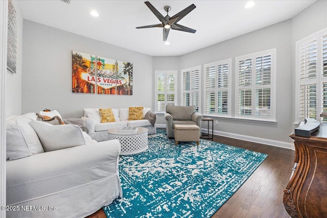 living room with ceiling fan and dark hardwood / wood-style floors