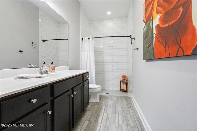 bathroom with vanity, curtained shower, and toilet