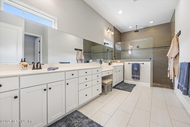 bathroom with vanity and a tile shower