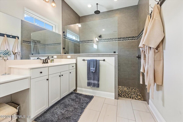 bathroom featuring vanity and tiled shower