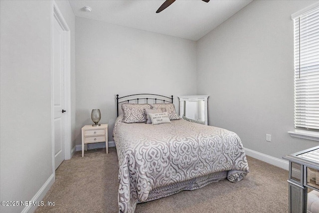 carpeted bedroom featuring multiple windows, vaulted ceiling, and ceiling fan