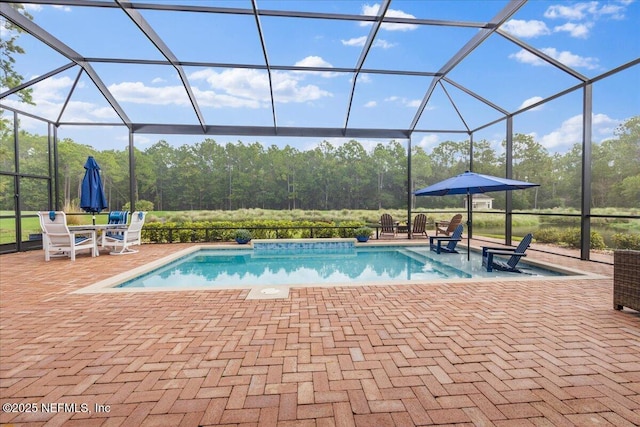 view of pool with a patio and glass enclosure