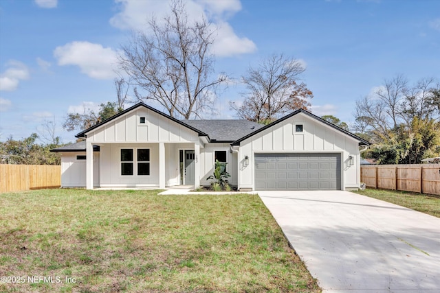 modern farmhouse featuring a garage and a front lawn