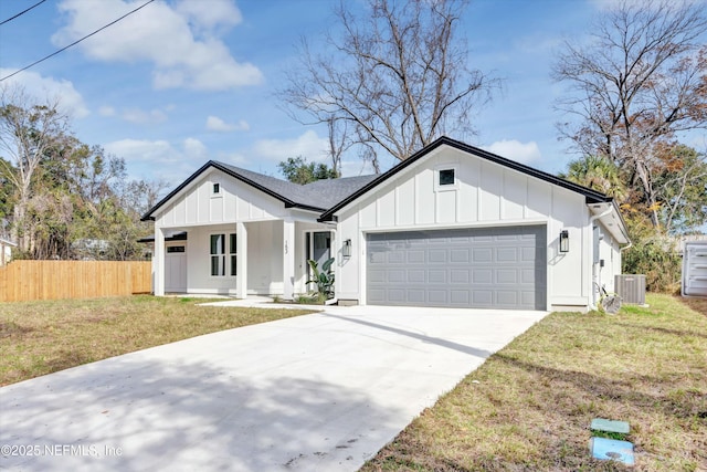 modern farmhouse with a garage, a front lawn, central air condition unit, and a porch