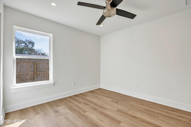 empty room featuring ceiling fan and light wood-type flooring