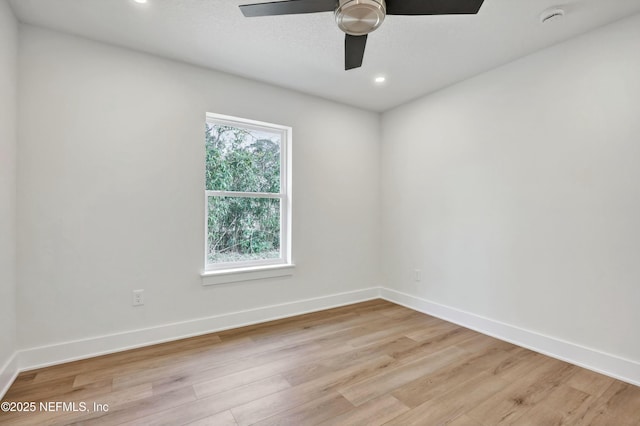 empty room featuring ceiling fan, a textured ceiling, and light hardwood / wood-style floors