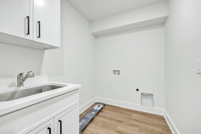 clothes washing area with sink, cabinets, washer hookup, light hardwood / wood-style floors, and electric dryer hookup