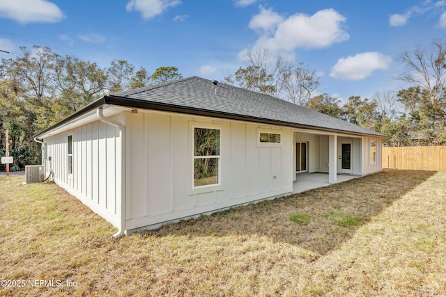 view of side of home featuring a yard, a patio, and central air condition unit