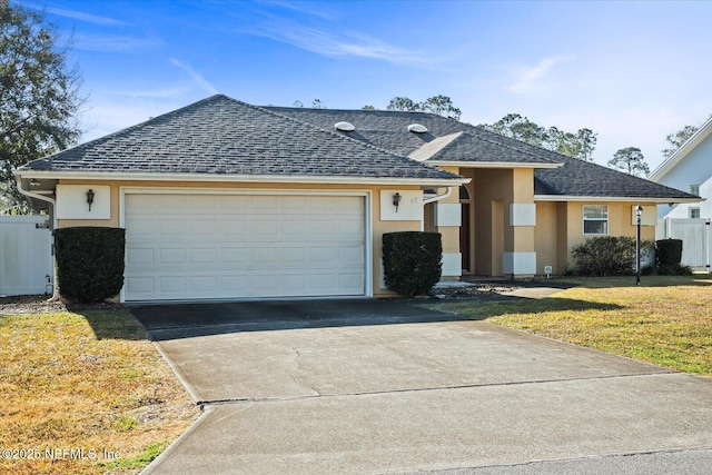 view of front of home featuring a garage and a front yard